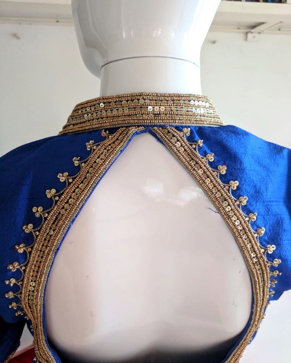 Royal blue raw silk blouse with elephant embroidery with orange brocade skirt