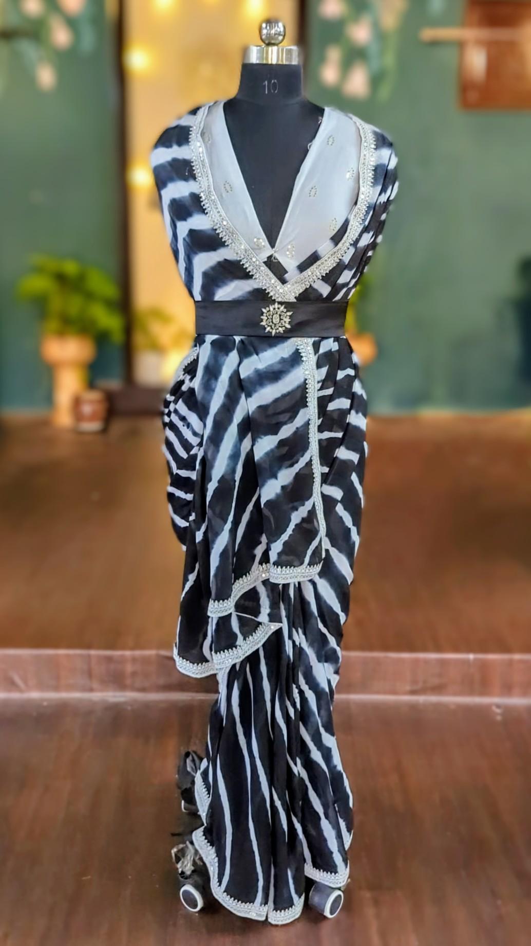 Beautiful black and white shibori hand dyed stripes saree with white raw silk blouse with sequin embroidery.