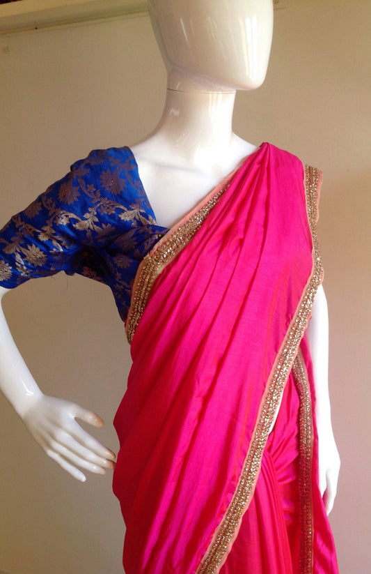 Glowing pink  semi silk saree with gold stone work border and unstitched blue silk brocade blouse