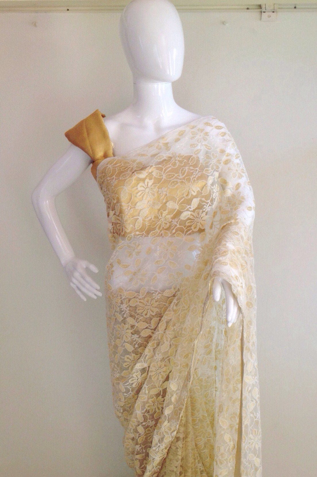 Gold and white lace saree with a gold blouse