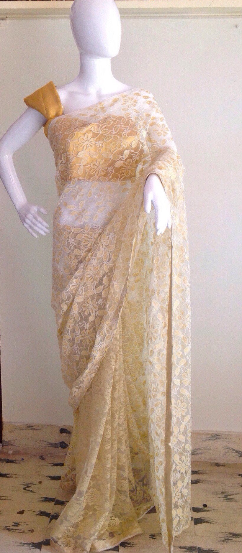 Gold and white lace saree with a gold blouse