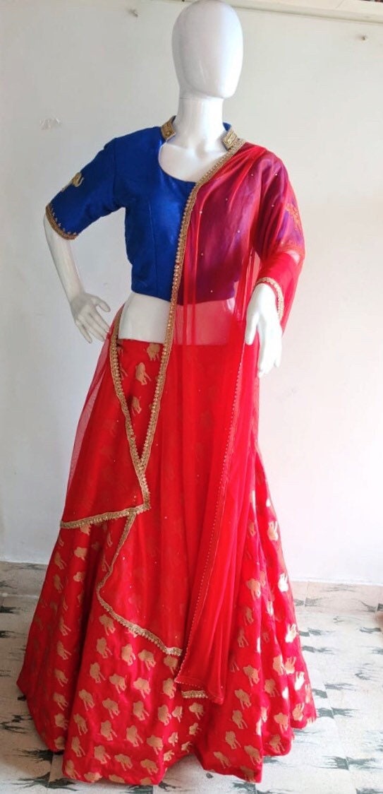Royal blue raw silk blouse with elephant embroidery with orange brocade skirt