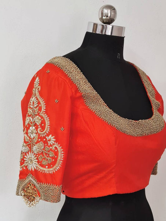 Orange raw silk blouse with beautiful maggam work