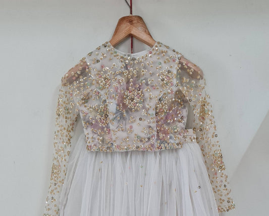 Off white floral blouse with net overlay and all over sequin work and  matching tulle skirt