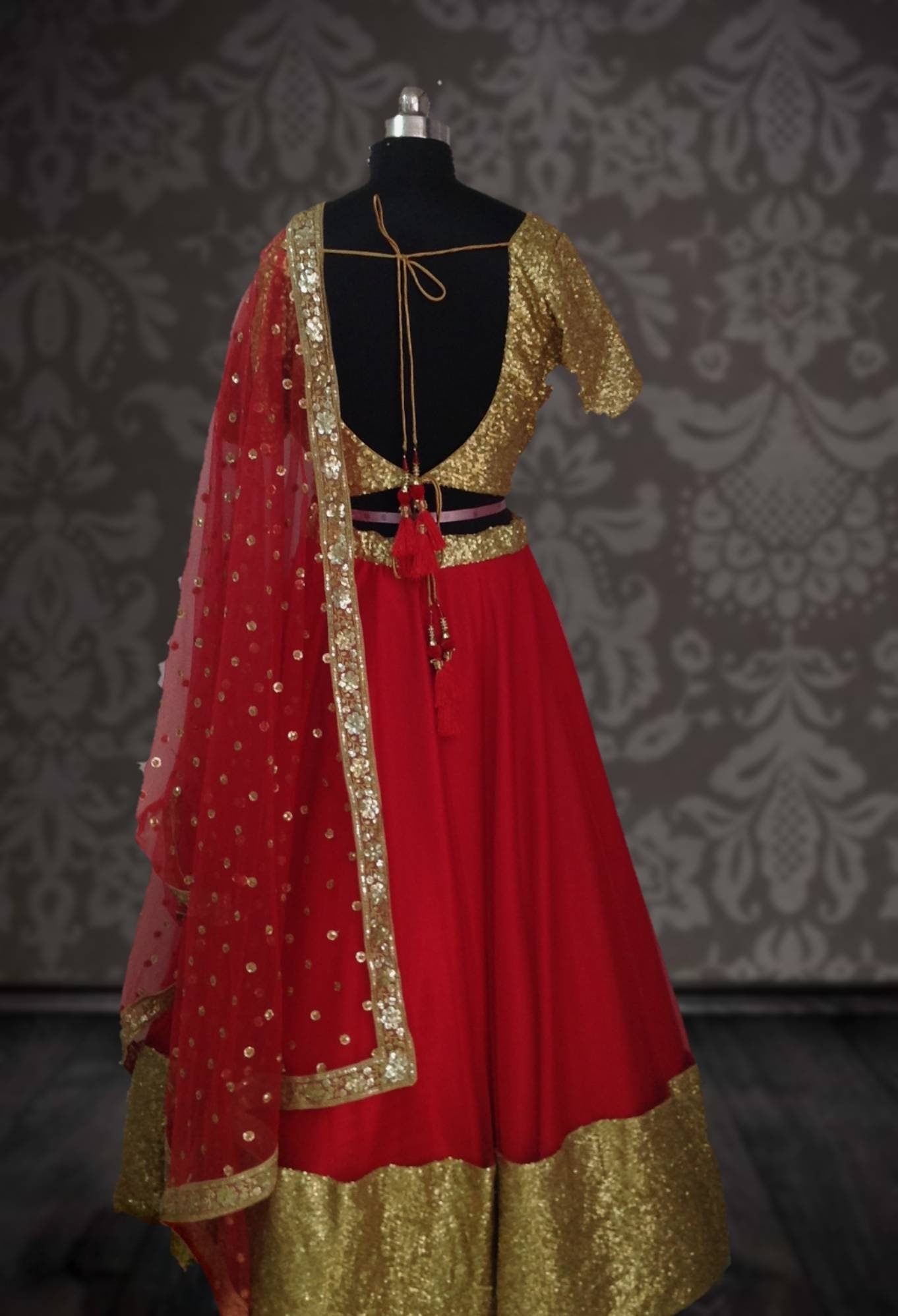 Bright red net lehenga with gold sequin blouse and sequin net dupatta