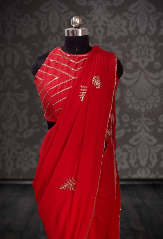 Bright tomato red georgette saree with copper hand embroidery and matching embroidery blouse