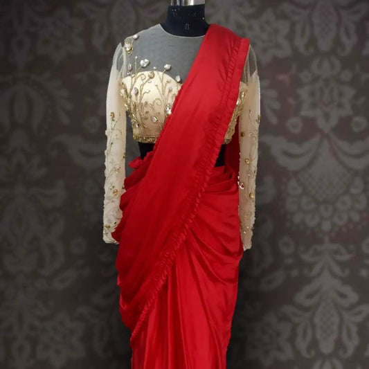 Red ready made satin saree with pleated border and stone embroidered blouse
