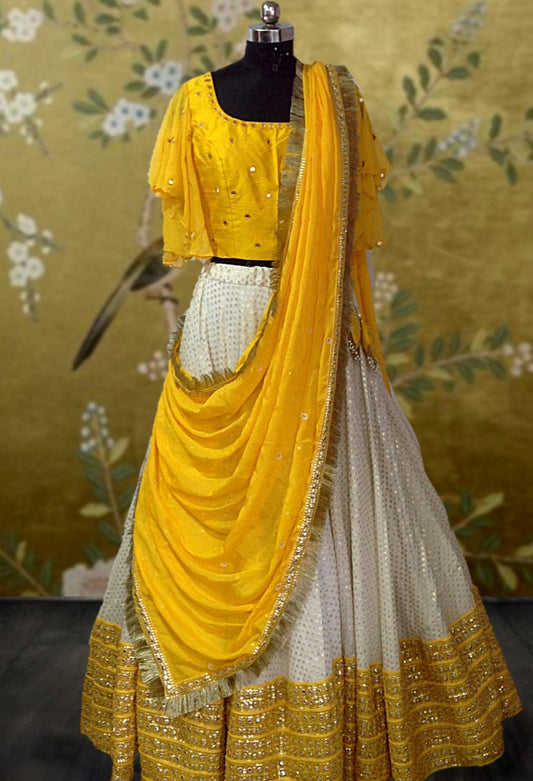 Yellow and white mirror work and brocade lehenga with flutter sleeved blouse