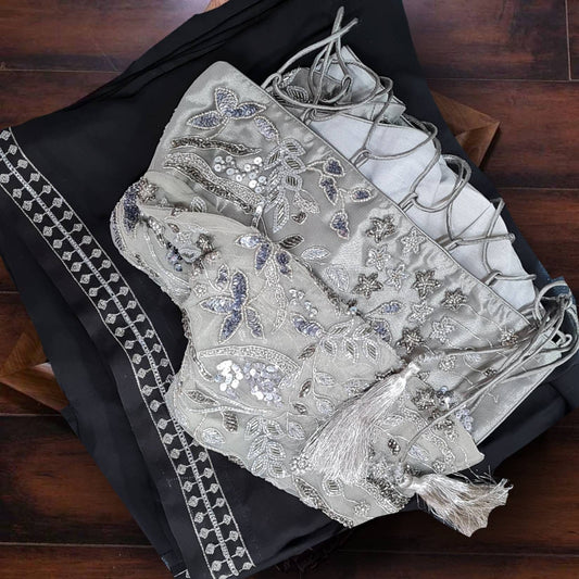 Black satin georgette saree and silver hand embroidered blouse