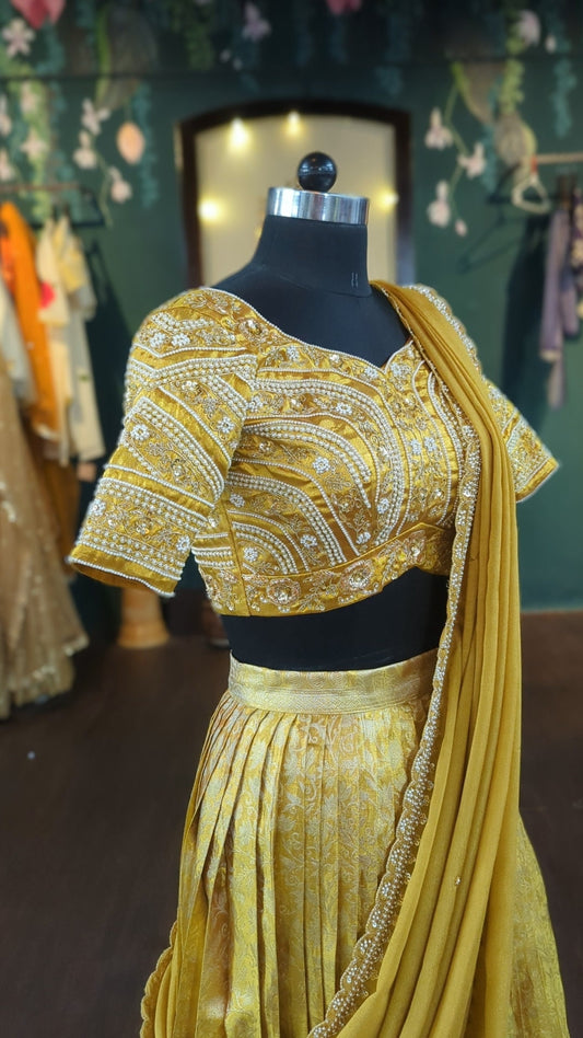 Gold Banarasi pleated lehenga with a fully embroidered blouse and dupatta