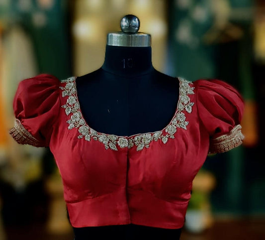 Red pure silk blouse with zardosi work on neck and puff sleeves.