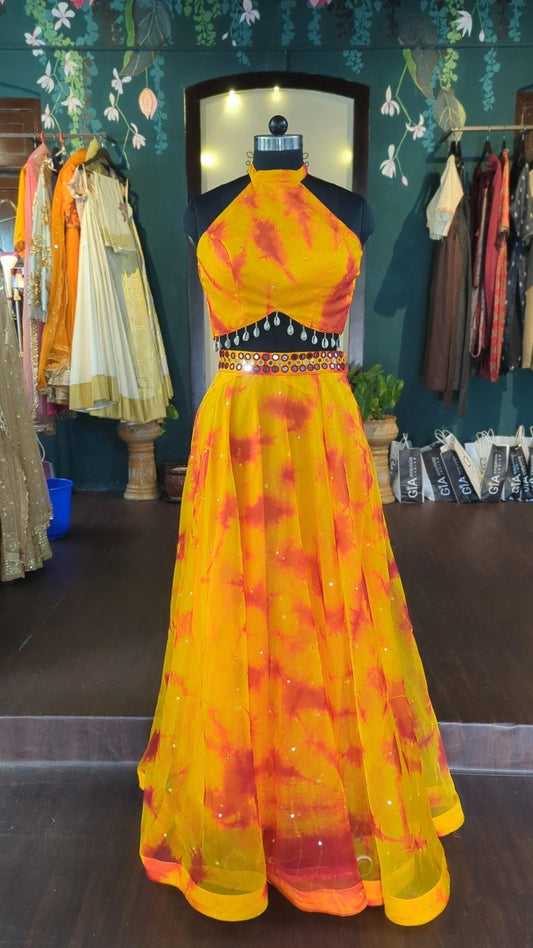 Mirror work halter neck shibori haldi lehenga in yellow and deep orange