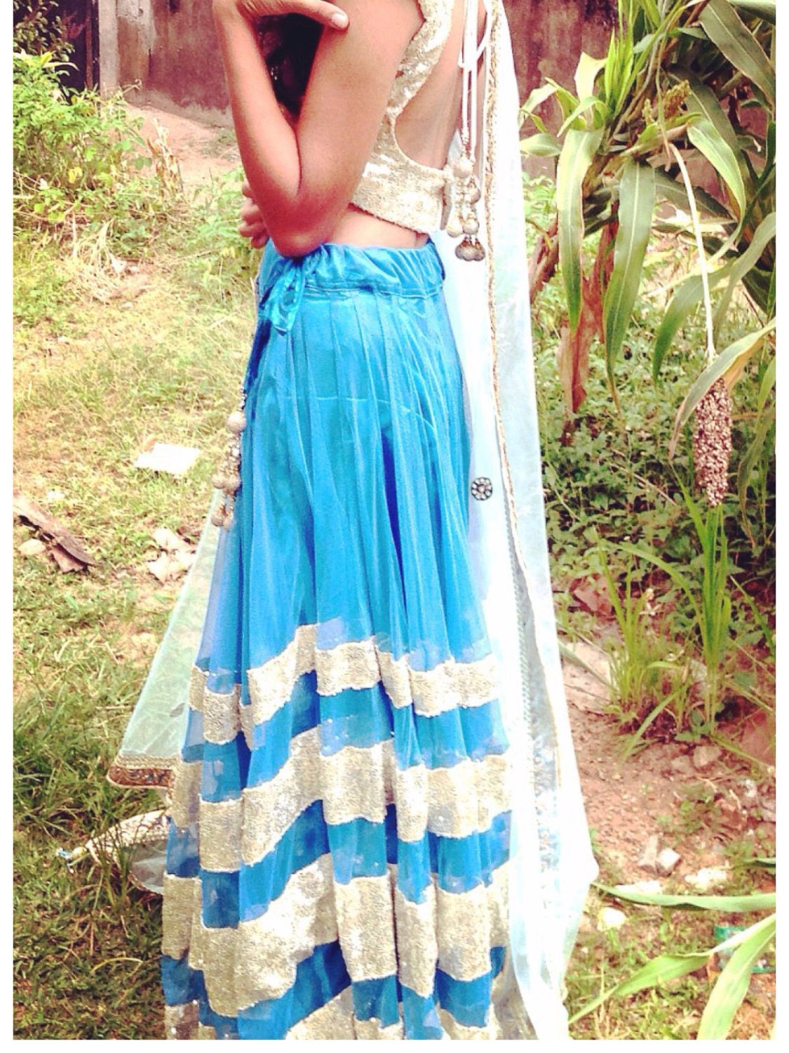 Blue net lehenga with seuin trim and gold sequin choli