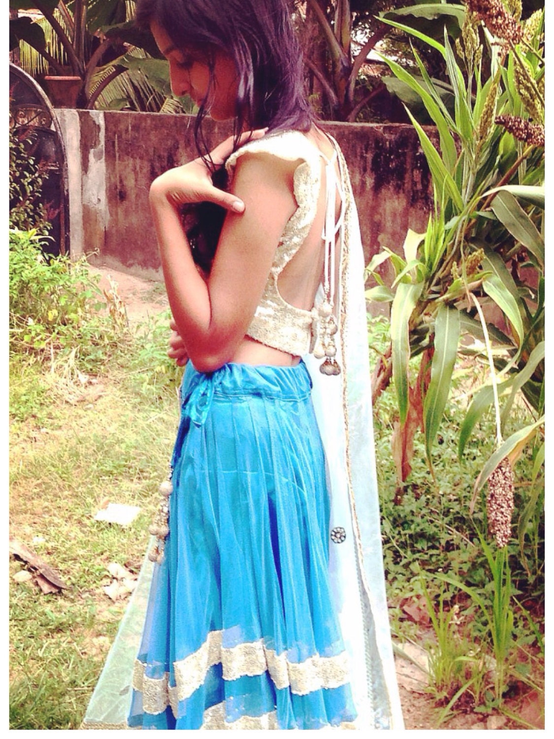 Blue net lehenga with seuin trim and gold sequin choli