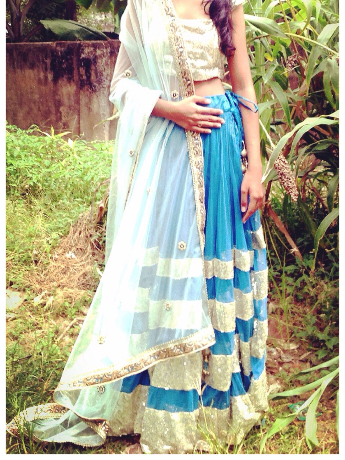 Blue net lehenga with seuin trim and gold sequin choli
