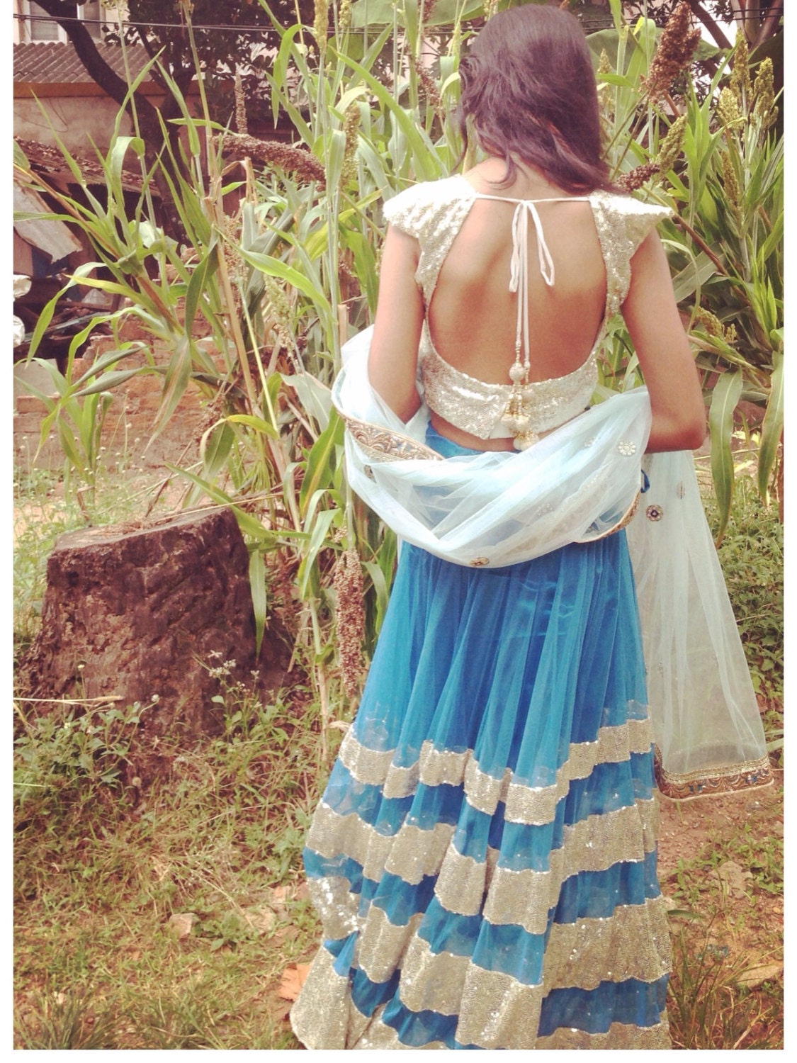 Blue net lehenga with seuin trim and gold sequin choli